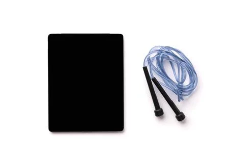 Flat lay top view jump rope and tablet with empty screen on white background 스톡 사진