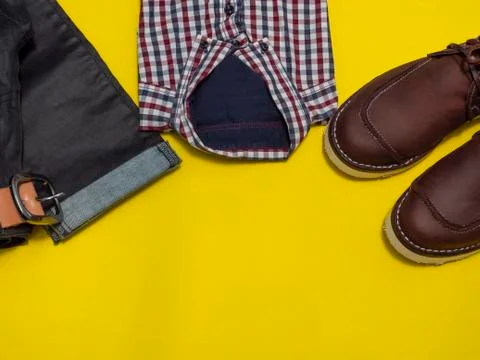 Flat lay, top view, men fashion casual clothing set isolated on yellow backgr Stock Photos