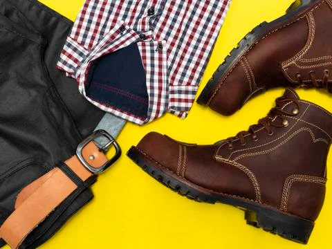 Flat lay, top view, men fashion casual clothing set isolated on yellow backgr Stock Photos