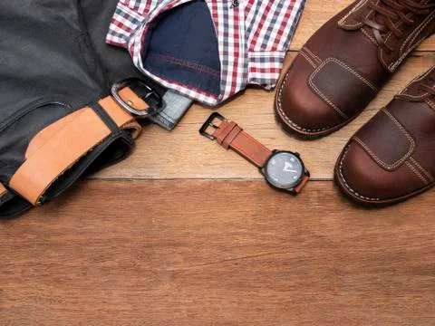 Flat lay, top view, men fashion casual clothing set isolated on wooden backgr Stock Photos