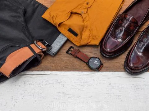 Flat lay, top view, men fashion casual clothing set isolated on wooden backgr Stock Photos