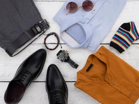 Flat lay, top view, men fashion casual clothing set on white wooden backgroun Stock Photos