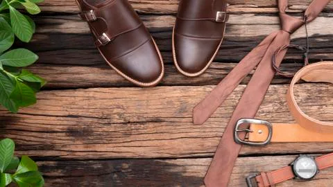 Flat lay, top view, men fashion clothing set and leather accessories on rusti Stock Photos