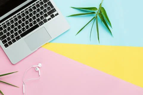 Flat lay top view mockup photo of working space with laptop, headphones and g Stock Photos