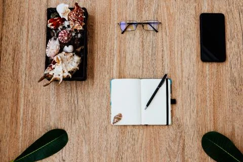 Flat lay, top view of a notepad with white paper on a light wooden table Stock Photos