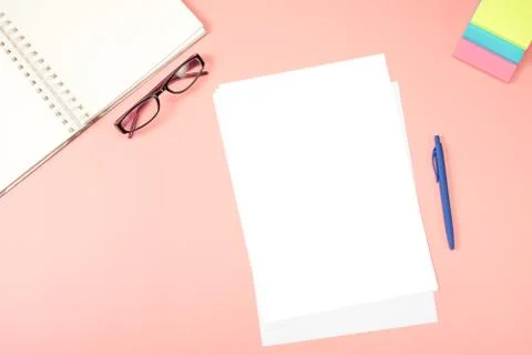 Flat lay, top view office desk. blank paper, eyeglasses, notepad, note paper  Stock Photos