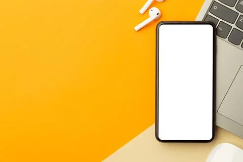Flat lay, top view of orange office table desk with smartphone blank screen.. Stock Photos