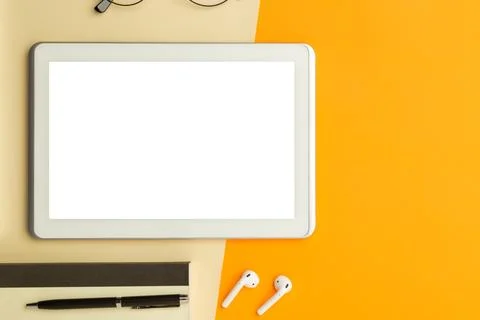 Flat lay, top view of orange office table desk with tablet computer screen .. Stock Photos