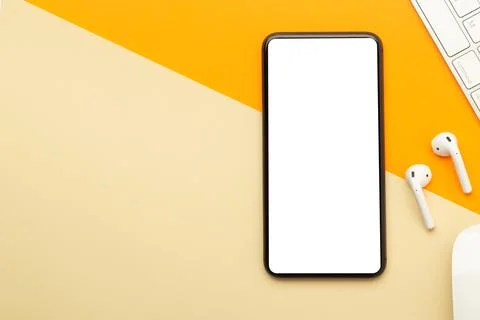 Flat lay, top view of orange office table desk with smartphone blank screen.. Stock Photos