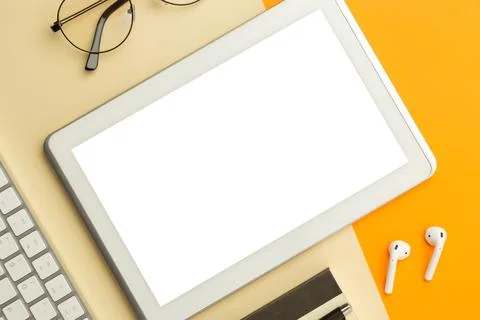 Flat lay, top view of orange office table desk with tablet computer screen .. Stock Photos