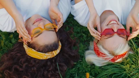 Flat lay, top view portrait of two young beautiful happy smiling girls wearing Stock Footage 111527557