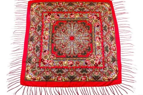 Flat lay top view on red cotton scarf with fringe and bright roses floral orn Fotos Stock