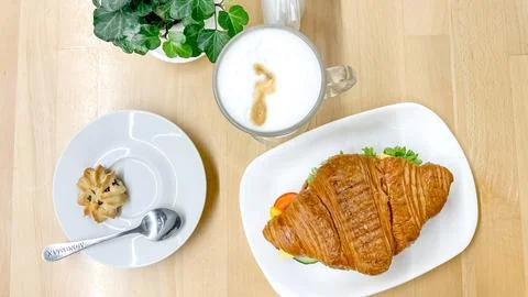 Flat lay top view of a savory croissant sandwich served with a hot coffee l.. Stock-Fotos