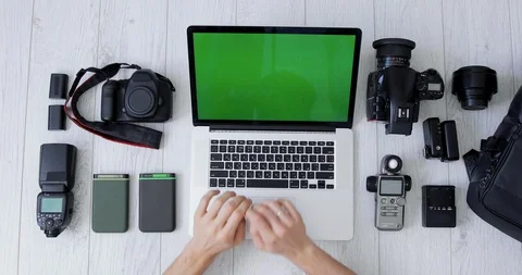 Flat Lay Top View shot of male hands are working on laptop with green screen Stock Footage 127704748