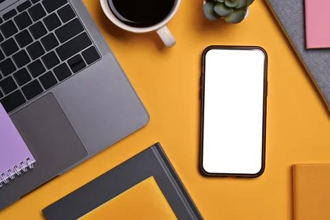 Flat lay, top view smartphone with blank screen, laptop, cup of coffee and book Stock Photos
