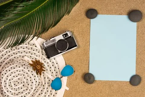 Flat lay, top view summer accessories:hat,note paper and seashell on the beac Stock Photos
