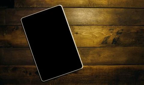 Flat lay top view tablet mockup on a vintage wooden desk Stock Photos