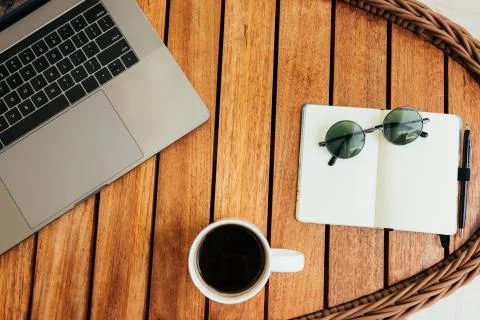 Flat lay, top view of the workspace with a laptop, on a brown wooden table Stock Photos