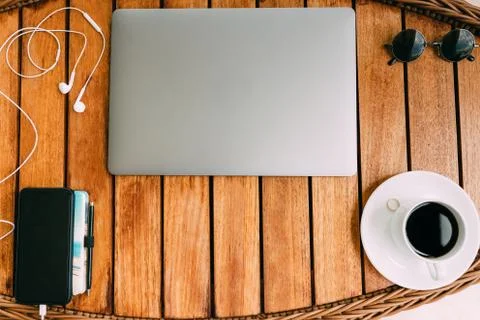 Flat lay, top view of the workspace with a laptop, on a brown wooden table Stock Photos