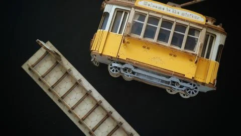 Flat lay top view of a yellow wooden tram model Stock-Fotos