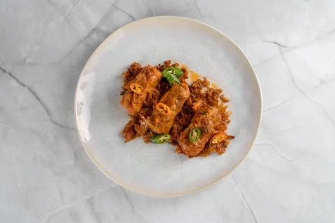 Flat lay of traditional cabbage rolls on minced cabbage Stock Photos