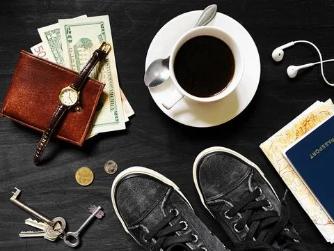Flat Lay of Travel Essentials with Coffee, Cash, Passport, and Sneakers Stock Photos