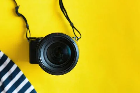 Flat lay traveler accessories on yellow background with blue dress, camera and Stock Photos