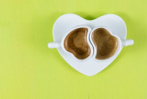 Flat lay with two cups of espresso on green board Stock Photos