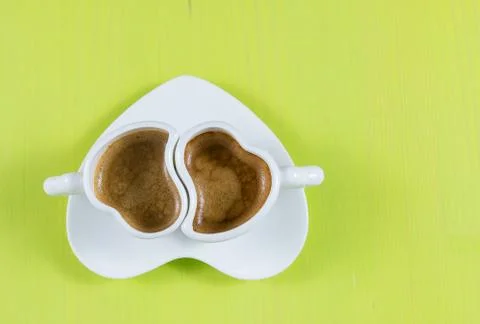 Flat lay with two cups of espresso on green board Stock Photos