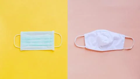 Flat lay of two different kind of medical mask and fabric mask on bright yell Foto stock