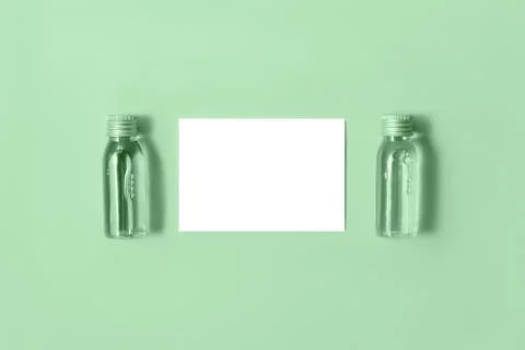 Flat lay of two small mockup bottles with spa cosmetic products on neo mint Stock Photos