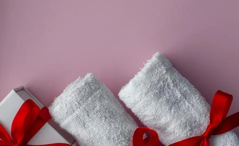 Flat lay with two white towels and gift box Stock Photos