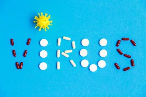 Flat lay typography made of pills and tablets and coronavirus symbol. Stock Photos