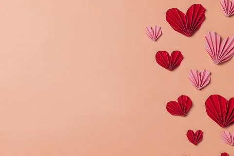 Flat lay valentine background with folded paper heart Stock Photos