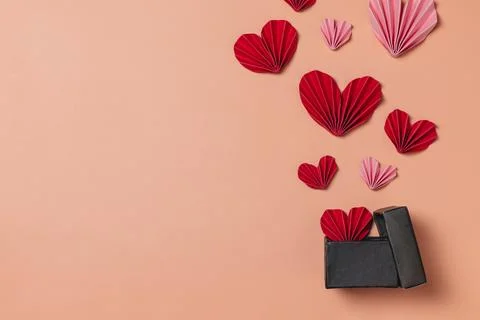 Flat lay valentine background with folded paper heart and gift box Stock Photos