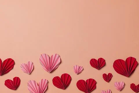 Flat lay valentine background with folded paper heart Stock Photos