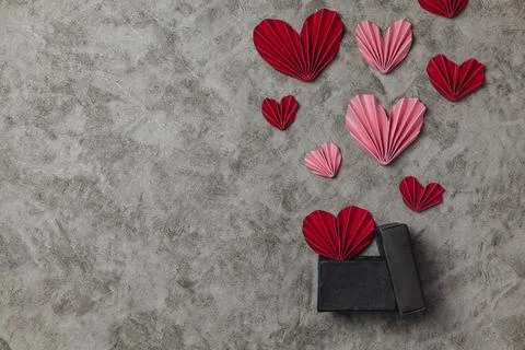 Flat lay valentine background with folded paper heart and gift box Stock Photos