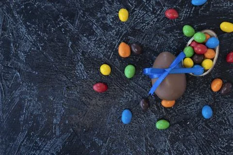 Flat lay of various chocolate sweets on a black texture background. big choco Stock Photos
