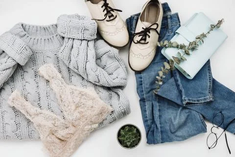 Flat lay of various cozy woman's clothes and accessories on white Foto stock