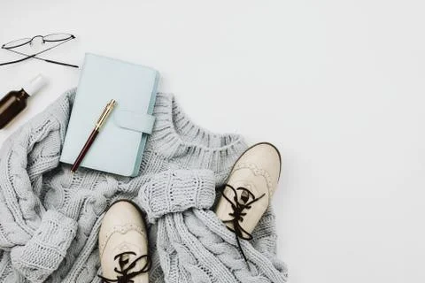 Flat lay of various cozy woman's clothes and accessories on white Stock Photos