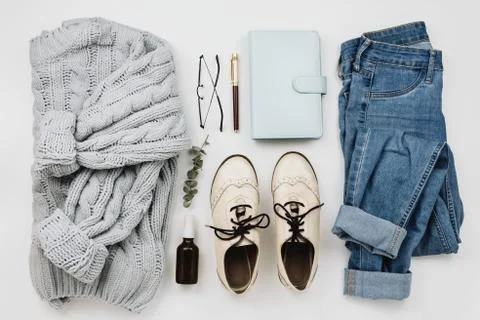 Flat lay of various cozy woman's clothes and accessories on white Stock Photos