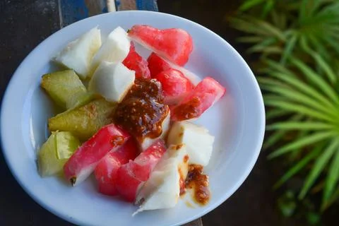 Flat lay various kinds of fruit made into "rujak" and seasoned with peanuts Stock Photos