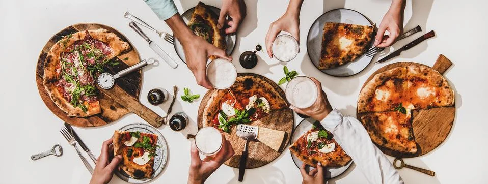Flat-lay of various pizzas, drinks and people celebrating with beer Stock Photos