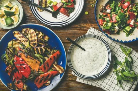 Flat-lay of vegan dinner table setting with healthy appetizers Stock Photos