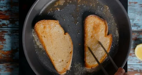 Flat lay video of the toasts are fried on the hot pan with butter, 4k Stock Footage 217946114