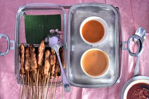 Flat lay view of chicken satay with peanut sauce Stock Photos