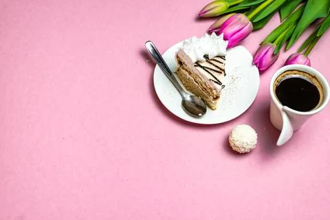 Flat lay view of desktop surface, tulips, coffee with cake and calculator on  Stock Photos
