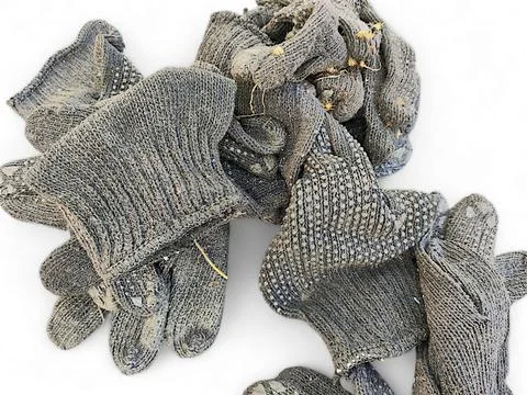 Flat lay view of dirty pile of black gloves Stock Photos