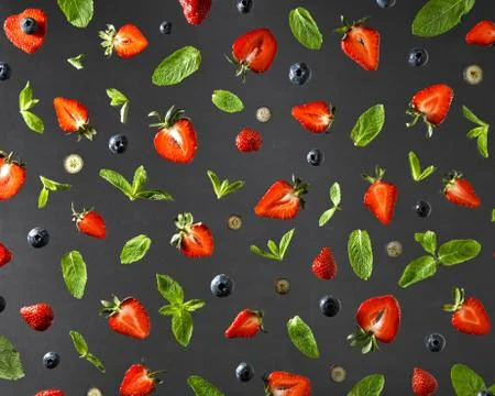 Flat lay view on fruit pattern with strawberries, blueberries and mint leaves on Stock Photos