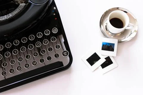 Flat lay view of mechanical typewriter with espresso and film slides Stock Photos